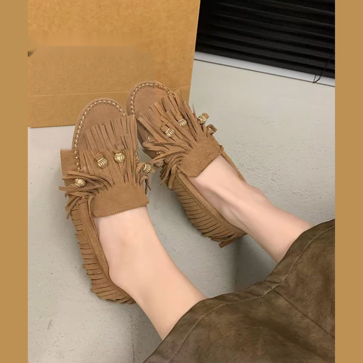 Camelkleurige dames mocassin met franjes gedragen