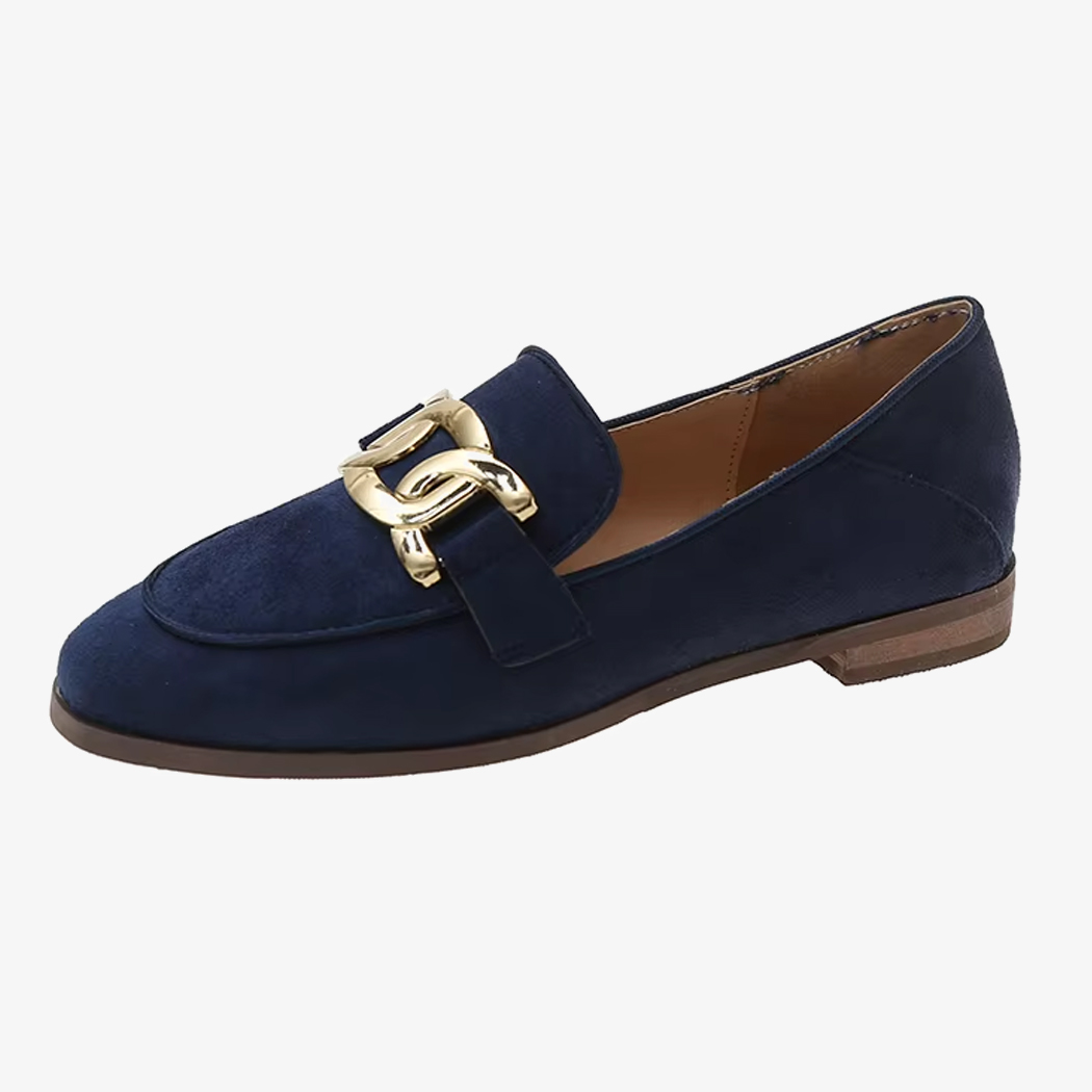 Een marineblauwe vintage loafer met gesp voor dames op een witte achtergrond